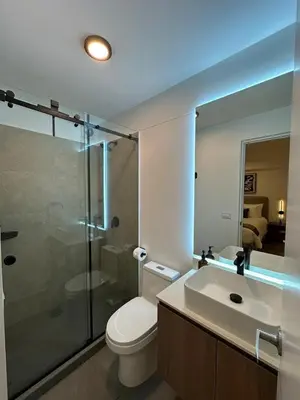 a bathroom with a toilet and a shower and a sink at 1BDR Modern apartment in Barranco in Lima