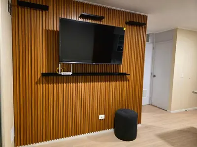 a living room with a wall with a television on it at Lujoso departamento y céntrico en Lima in Lima