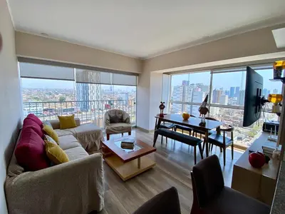a living room with a couch and a table at Large Apartment - Santa Beatriz 3 Bedrooms in Lima