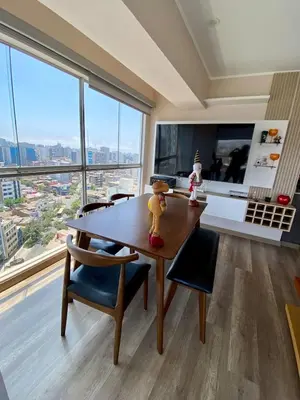 a kitchen with a wooden table and chairs and a large window at Large Apartment - Santa Beatriz 3 Bedrooms in Lima