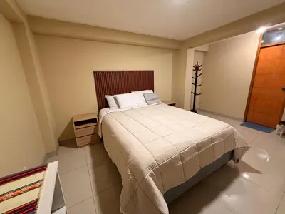 a bedroom with a bed in a room at Tres Cruces Private Rooms in Cusco