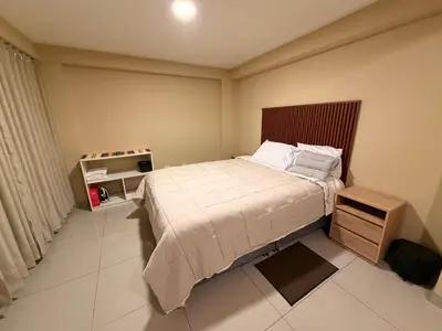 a small bedroom with a bed and a night stand at Tres Cruces Private Rooms in Cusco