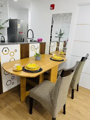 a kitchen with a wooden table and two chairs at Apartamento moderno en Miraflores in Lima