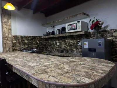 a kitchen with a counter top and a refrigerator at Rustic Getaway in San Bartolo in San Bartolo