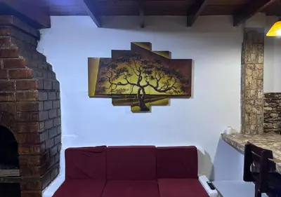 a painting of a tree on a wall at Rustic Getaway in San Bartolo in San Bartolo