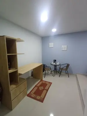 a room with a desk and a table and chairs at La Casa de la Emperatriz in Ica
