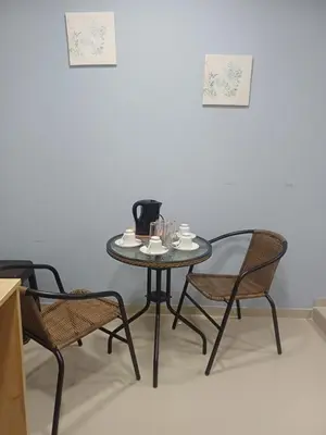a table and chairs with cups and coffee on it at La Casa de la Emperatriz in Ica