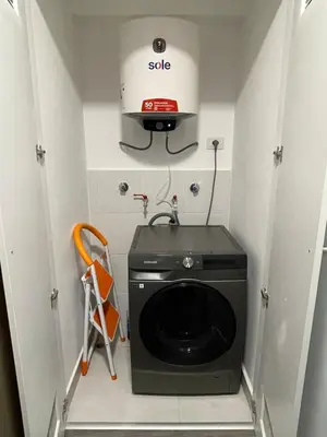 a kitchen with a washing machine in a room at 5 stars Stylish Andean Stay - CUSCO in Cusco