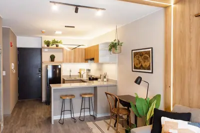 a kitchen and living room with a counter and stools at 5 stars Stylish Andean Stay - CUSCO in Cusco