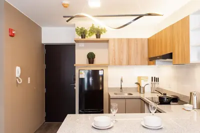 a kitchen with a black refrigerator and a counter at 5 stars Stylish Andean Stay - CUSCO in Cusco