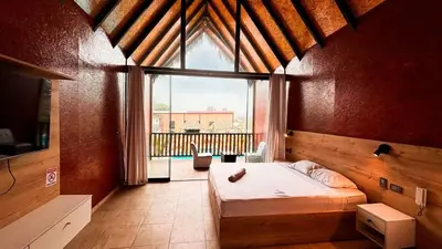 a bedroom with a bed and a large window at Club InkaVida - Pachacamac in Pachacamac