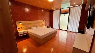 a bedroom with a large white bed in a room at Club InkaVida - Pachacamac in Pachacamac