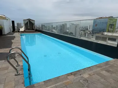 a swimming pool on the roof of a building at Departamento Graña in Lima