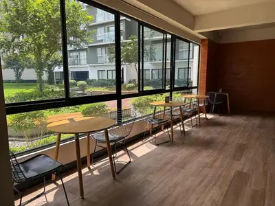 a room with tables and chairs and large windows at Departamento Graña in Lima