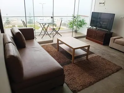 a living room with a couch and a coffee table at Apartment facing Mirador Analí in Punta Hermosa
