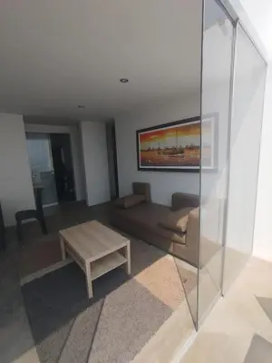 a living room with a couch and a coffee table at Apartment facing Mirador Analí in Punta Hermosa
