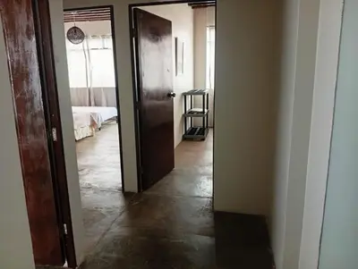 a hallway with a door leading to a bedroom at Apartment facing Mirador Analí in Punta Hermosa
