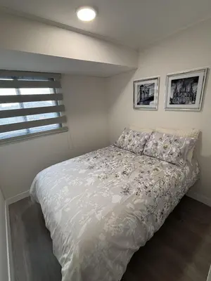 a bedroom with a bed with white sheets and a window at 2BR Apartment with Pool near Larcomar in Lima