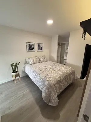 a bedroom with a bed and a table in it at 2BR Apartment with Pool near Larcomar in Lima