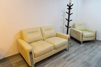 a yellow couch and two chairs in a room at Lama Vista Living 302 in Cusco