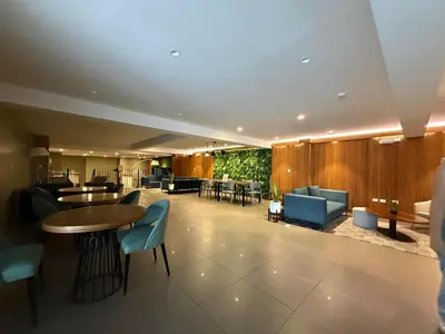a lobby with a table and chairs at Barranco Bohemio, Modern and Bright Apartment in Lima