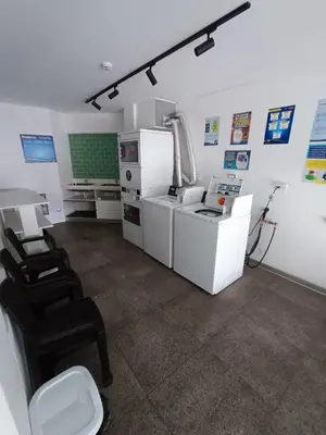 a kitchen with a counter and chairs in a room at Barranco Bohemio, Modern and Bright Apartment in Lima