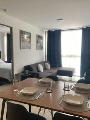 a living room with a table and a couch at Barranco Bohemio, Modern and Bright Apartment in Lima