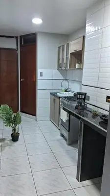 a kitchen with a counter and a stove in it at Sweet Home in Lima