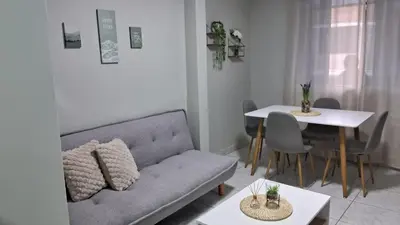a living room with a couch and a table at Sweet Home in Lima