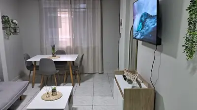 a living room with two tables and a tv at Sweet Home in Lima