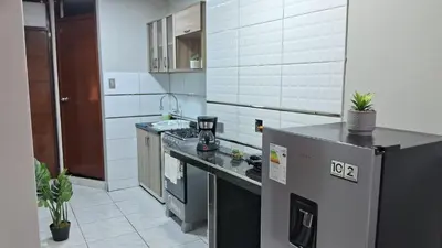 a kitchen with a refrigerator and a counter top at Sweet Home in Lima