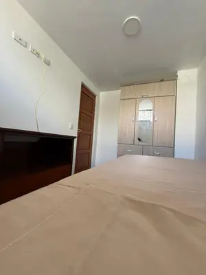 an empty room with a bed and a tv at Habitacion San Borja in Lima