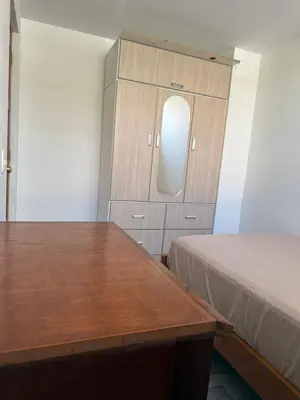 a room with a bed and a table and a mirror at Habitacion San Borja in Lima
