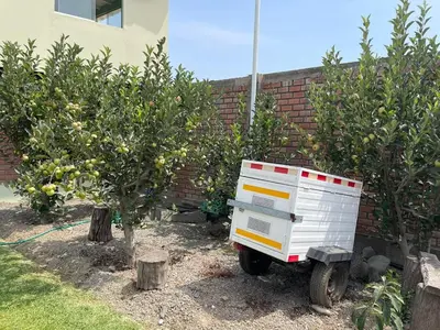 a white appliance sitting next to two apple trees at Hermosa Casa de Campo en Azpitia in Santa Cruz de Flores