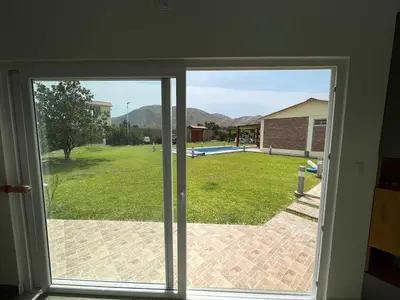 an open door with a view of a yard at Hermosa Casa de Campo en Azpitia in Santa Cruz de Flores