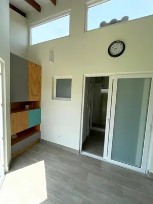 a room with a clock on the wall and a mirror at Hermosa Casa de Campo en Azpitia in Santa Cruz de Flores