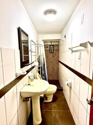 a bathroom with a white sink and a toilet at Comfort House in Lima
