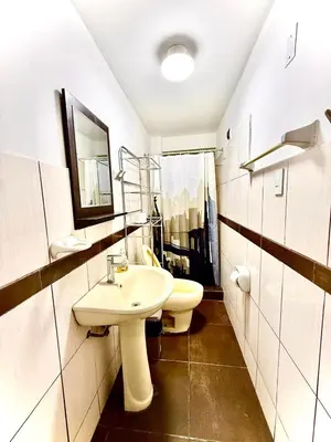 a bathroom with a white sink and a toilet at Comfort House in Lima