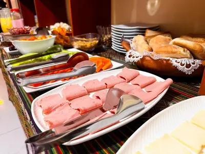 a table topped with plates of food and bread at Cusco - Flor de Loto in Cusco