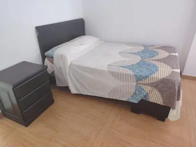 a bedroom with a bed and a dresser in a room at Ocean Glips II in Punta Negra