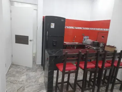 a kitchen with a table and chairs and a refrigerator at Ocean Glips II in Punta Negra