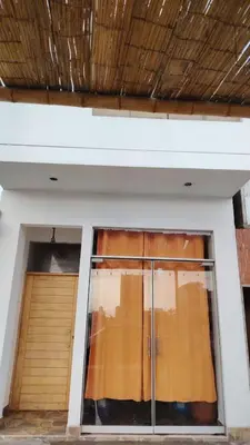 a window in a building with a wooden door at Ocean Glips II in Punta Negra