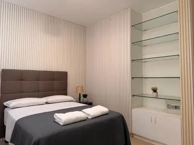 a bedroom with a bed with two towels on it at Huacachina Boutique Hotel in Ica