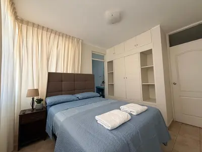 a bedroom with a bed with two towels on it at Huacachina Boutique Hotel in Ica