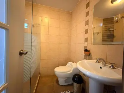 a bathroom with a toilet and a sink at Huacachina Boutique Hotel in Ica