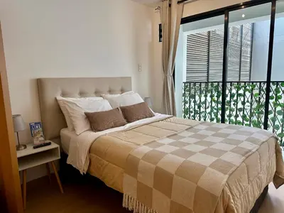 a bedroom with a large bed with a window at Mini Patria - Cozy apartment in Barranco in Lima