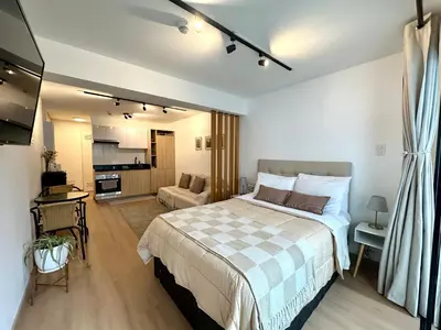 a bedroom with a bed and a living room at Mini Patria - Cozy apartment in Barranco in Lima