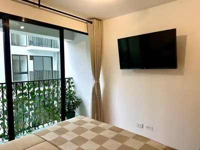 a bedroom with a flat screen tv on the wall at Mini Patria - Cozy apartment in Barranco in Lima
