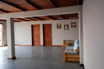 a living room with wooden ceilings and wooden doors at Casa Matta in Sunampe