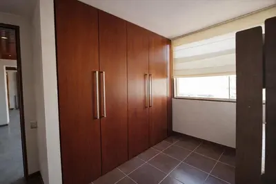 a room with wooden cabinets and a window at Casa Matta in Sunampe